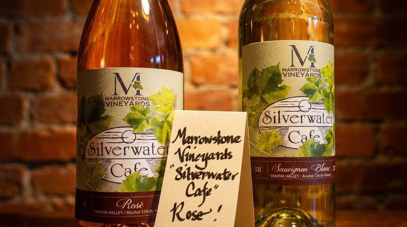 Two bottles of Marrowstone Vineyards "Silverwater Cafe" wine, rosé and Sauvignon Blanc, with a handwritten sign.