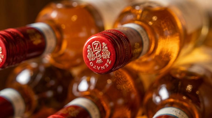Close-up of Zenato wine bottles with red and gold foil tops, showcasing the brand logo.